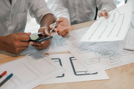 user experience UX designer designing web on smart phone layout. UI planning mobile application. developer work with business prototypeの写真素材