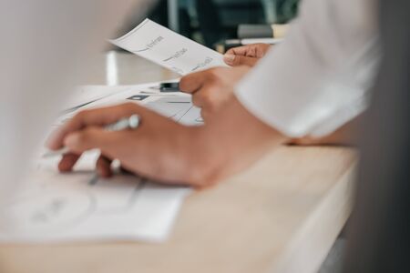 user experience UX designer designing web on smart phone layout. UI planning mobile application. developer work with business prototypeの写真素材