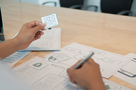 user experience UX designer designing web on smart phone layout. UI planning mobile application....