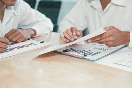 financial adviser analyzing performance revenue with investor. business people discussing in meeting. businessman working with co-worker team.の写真素材