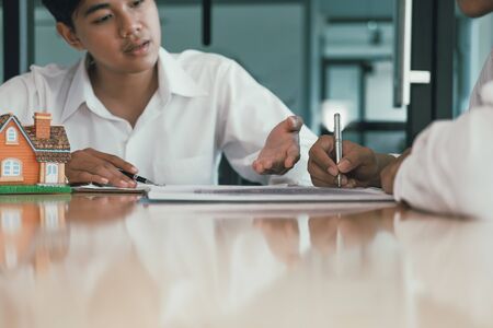 man signing contract agreement with realtor. buying, selling buying renting real estate propertyの写真素材