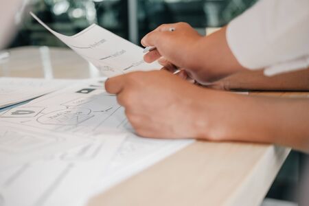 user experience UX designer designing web on smart phone layout. UI planning mobile application. developer work with business prototypeの写真素材