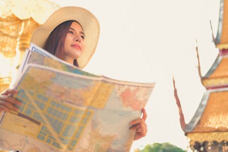 young asian woman traveler tourist with map. journey trip travel conceptの写真素材
