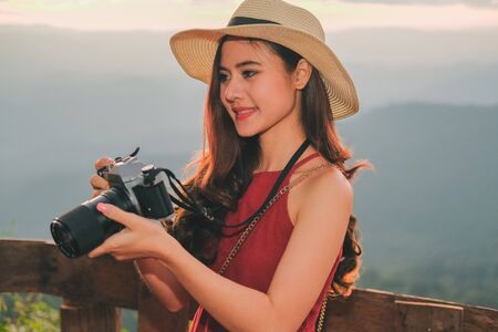 asian woman take photo. traveler tourist travel on holiday vacation. journey trip conceptの写真素材