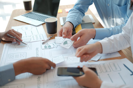 user experience UX designer designing web on smart phone layout. UI planning mobile application....