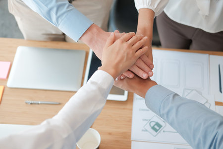 businessman businesswoman joining united hand, business team touching hands together after complete...