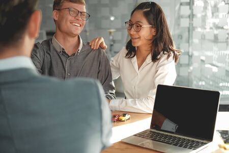 couple consulting lawyer about buying renting house car. insurance broker financial advisor giving legal advice to customer.realtor selling real estate property to clientの写真素材