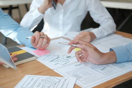 user experience UX designer designing web on smart phone layout. UI planning mobile application....