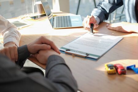 real estate agent dealer salesman using stamper for stamping approved on mortgage loan auto insurance contract agreement documentの写真素材