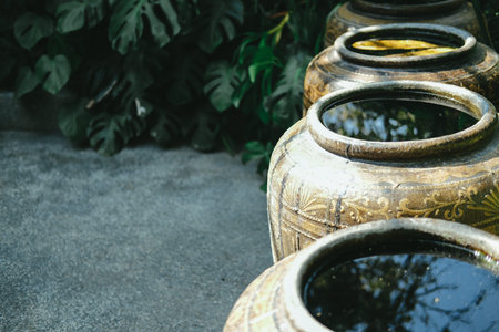 earthen water jar in garden. rain pot reservoir from Thailand