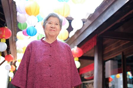 old elderly elder female woman with paper lantern. senior leisure lifestyleの写真素材