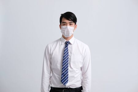businessman man wearing protective mask against cold flu covid 19 virus bacteria infection pollutionの写真素材