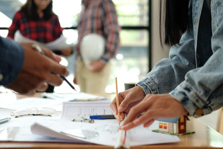 architect engineer interior designer team working discussing on house blueprint of real estate...