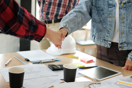 engineer team handshaking. architect shaking hands for successful deal in building construction...