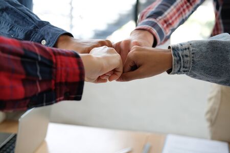 startup man woman joining united hand, business team touching hands together after complete a deal in meeting. unity teamwork partnership corporate concept.の写真素材