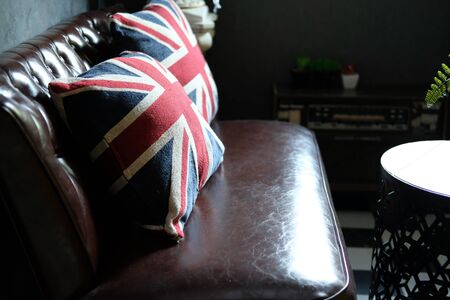 british flag pillow on brown leather sofa couch in living room interiorの写真素材