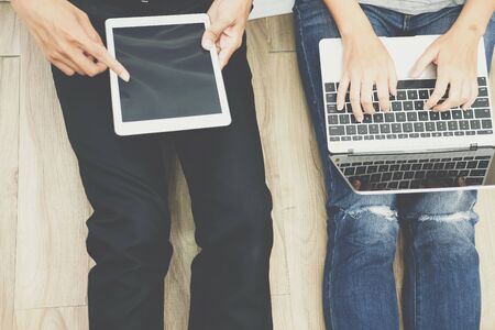 man woman friends using computer tablet. startup teamwork team working together at homeの写真素材