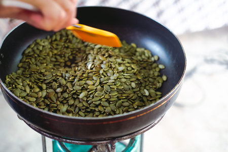 grilling toasting roasting pumpkin seed cereal on pot