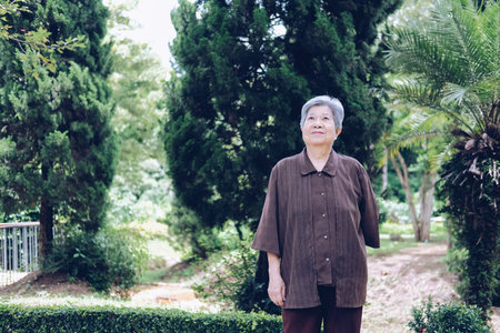 elder woman resting in garden. asian elderly female relaxing outdoors. senior leisure lifestyle
