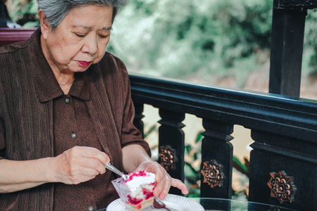 asian elder female woman resting relaxing on balcony terrace at home. elderly senior leisure...