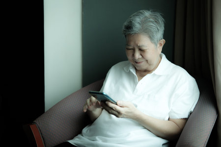 asian elder senior woman using mobile smart phone. elderly female holding cellphone. mature...