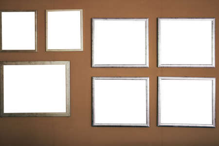 empty blank silver picture photo frame on brown wallの写真素材