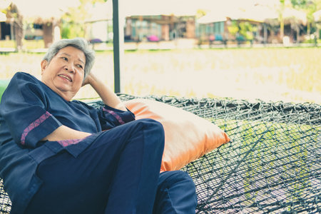 asian elderly woman elder  resting relaxing outdoors. senior leisure lifestyleの写真素材