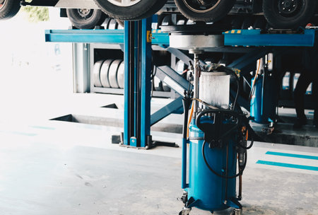 motor oil container for filling old engine oil from car in automobile repair service garageの写真素材