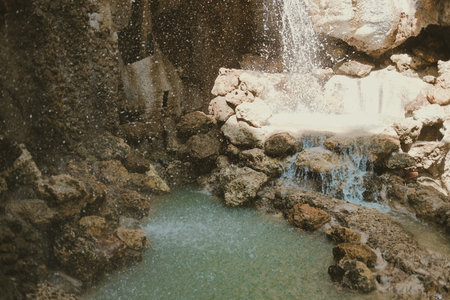 manmade waterfall park. flowing water stream in garden