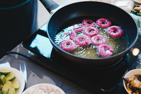 frying purple sweet potato doughnut. deep fried doughnuts dessertの写真素材