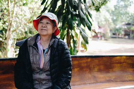 asian old elderly female elder woman resting relaxing in park. senior leisure lifestyle
