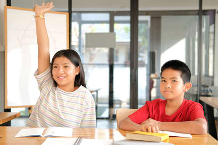asian girl boy student studying raising hand in classroom. learning education at schoolの写真素材