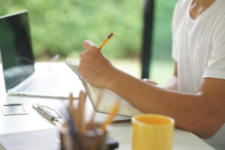 asian young teenage student man teenager entrepreneur working with computer writing note studying...