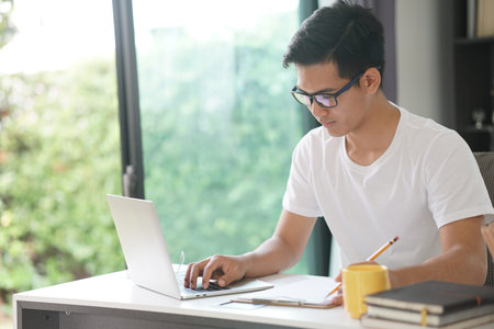 asian young teenage student man teenager entrepreneur working with computer studying learning online...