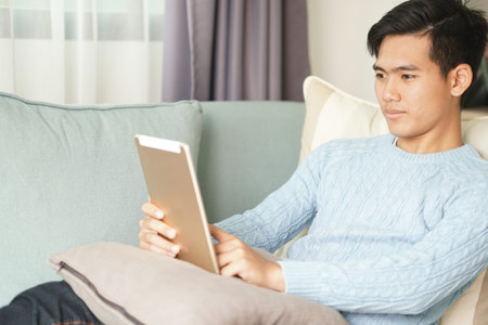 asian young teenage student man teenager entrepreneur working with tablet computer studying learning...