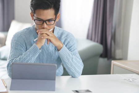 asian young teenage student man teenager entrepreneur working with tablet studying learning online...