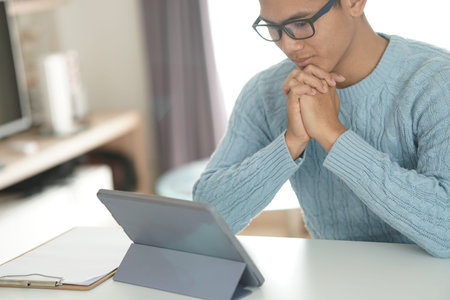 asian young teenage student man teenager entrepreneur working with tablet studying learning online...