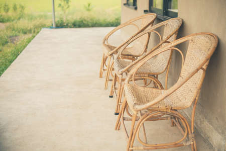 wicker rattan chair on balcony terrace patio for resting near gardenの写真素材