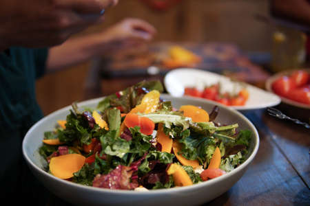 woman preparing cooking making vegetable salad in kitchenの写真素材