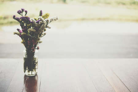 flower bouquet in glass vase on wooden table at patioの写真素材