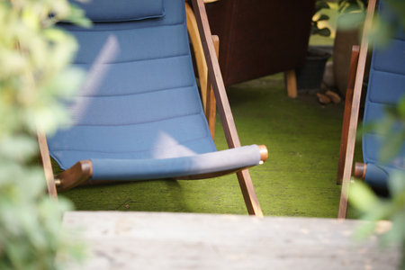 blue fabric collapsible chaise lounge for resting. deck chair deckchairの写真素材