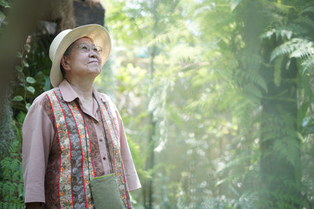 asian old elderly female elder woman resting relaxing in garden. senior leisure lifestyle