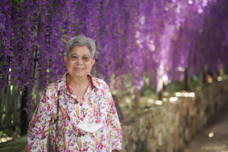 old elderly elder senior woman resting relaxing walking in gardenの写真素材