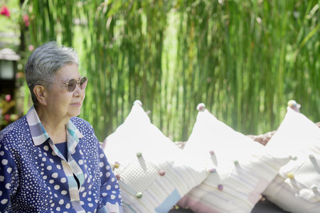 old elderly elder senior woman resting relaxing walking in gardenの写真素材