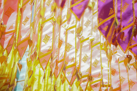 colorful traditional fabric flag decorating hanging in templeの写真素材