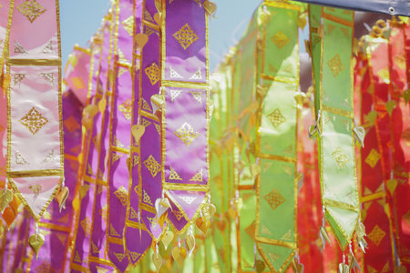 colorful traditional fabric flag decorating hanging in templeの写真素材