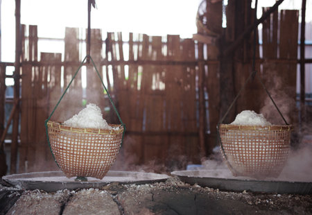 boiling saline solution in pan is traditional way for making mountain rock saltの写真素材