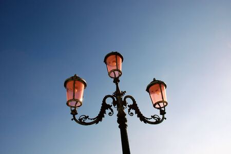 Ornate street lamp against clear sky background. Plenty of copy-space.の写真素材