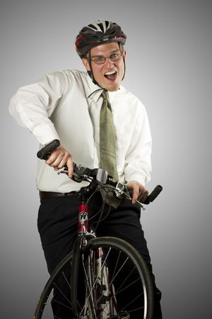 A happy businessman with a helmet riding a bikeの写真素材