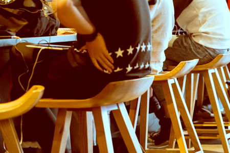 Boy group sitting on the wooden chair in coffee shopの写真素材